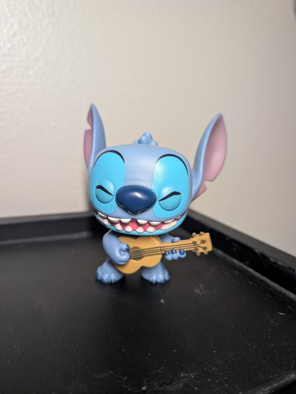 Funko Stitch Figure in Blue with Pink Ear Accents and Tan Guitar